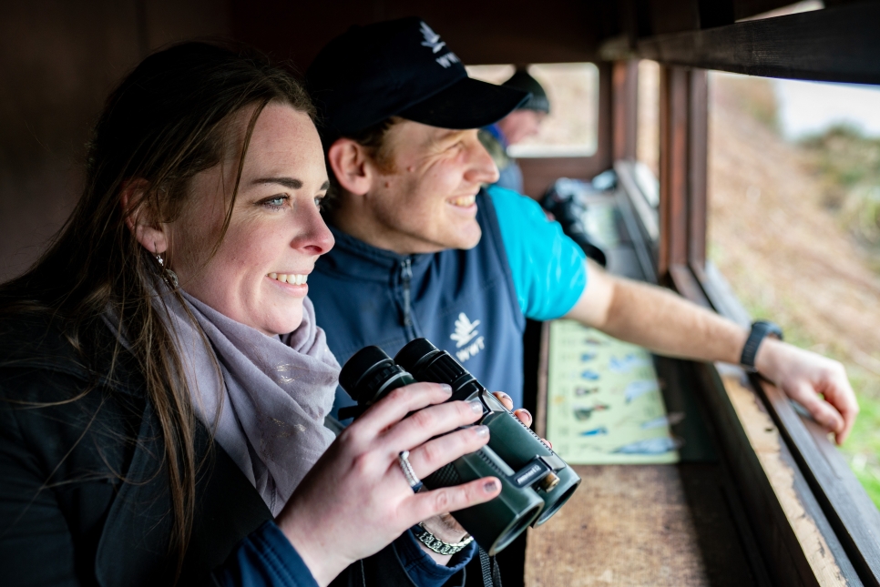 WWT Washington reserve warden Andrew Diamond and visitor in bird hide.jpg